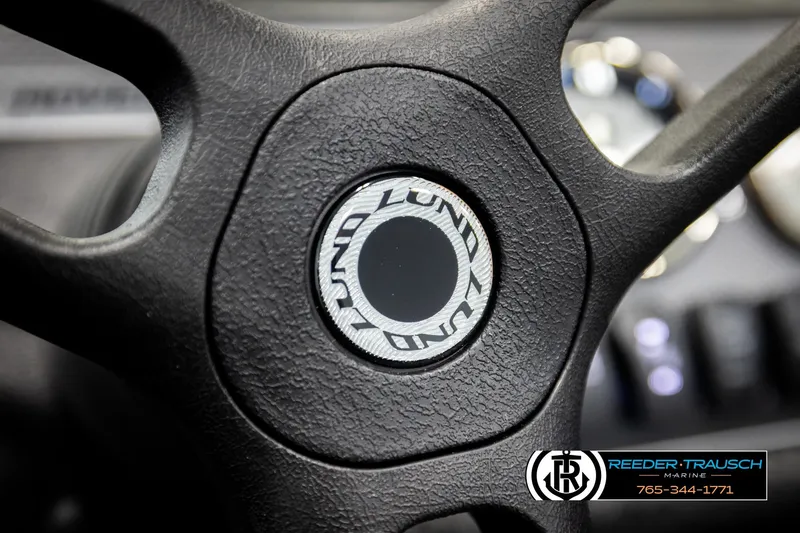 Slide: The Image of Steering wheel of 2026 Lund 1775 Adventure SS boat, featuring Reeder-Trausch Marine logo. - 28
