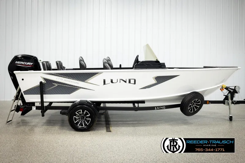Slide: The Image of 2026 Lund 1775 Adventure SS boat on trailer, featuring Mercury engine, displayed indoors. - 3