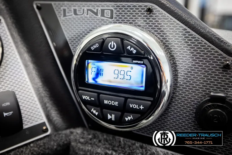 Slide: The Image of 2026 Lund 1775 Adventure SS boat dashboard with FM radio display at 99.5 frequency. - 31