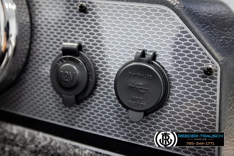 Slide: The Image of 2026 Lund 1775 Adventure SS dashboard with 12V and USB ports, Reeder-Trausch Marine logo. - 32