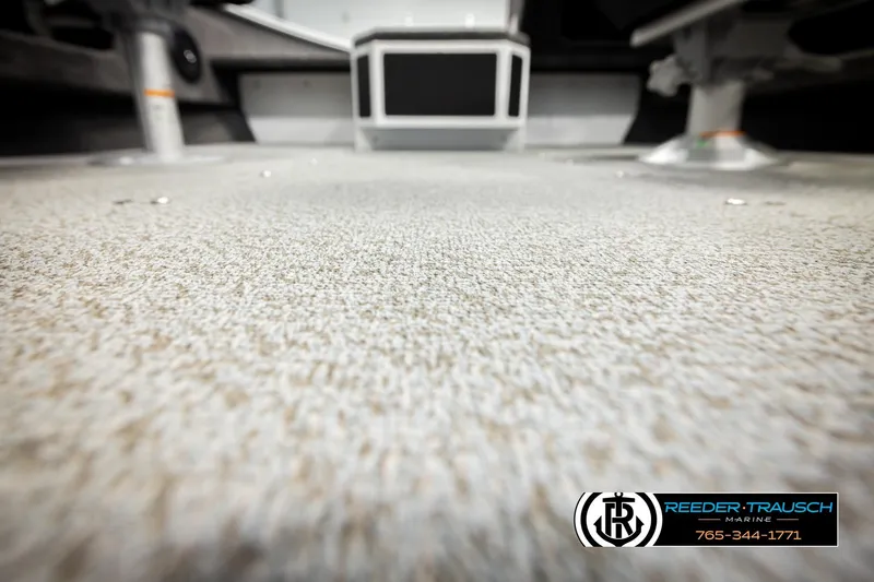 Slide: The Image of 2026 Lund 1775 Adventure SS boat interior with textured flooring, Reeder-Trausch Marine logo visible. - 39