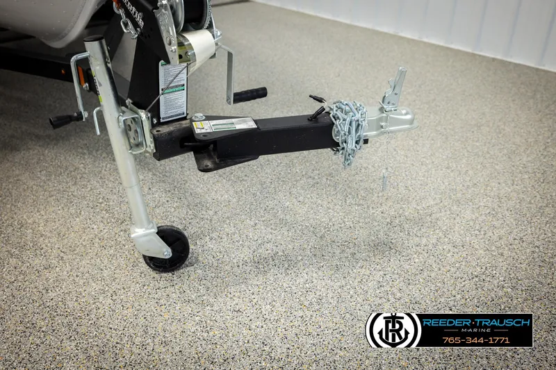 Slide: The Image of Trailer hitch of 2026 Lund 1775 Adventure SS on speckled floor, Reeder-Trausch Marine branding. - 44