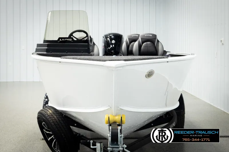 Slide: The Image of 2026 Lund 1775 Adventure SS boat in showroom, featuring sleek design and modern seating. - 6