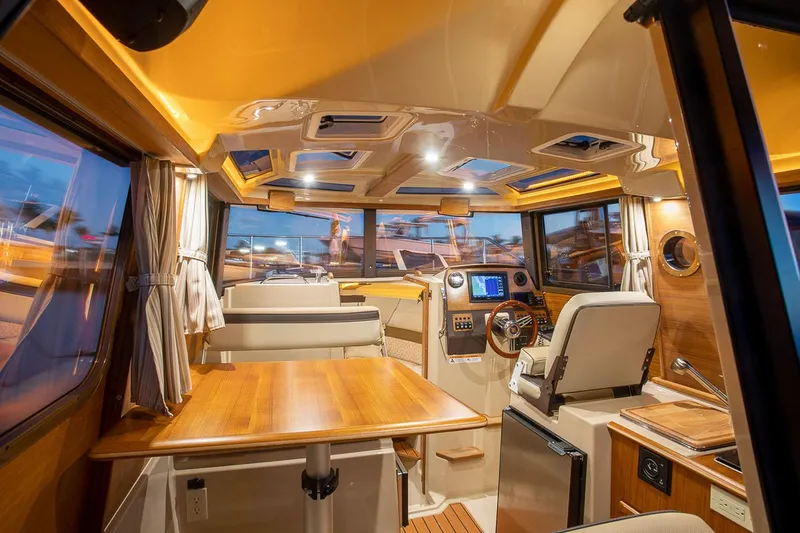 Slide: The Image of Manufacturer Provided Image: Interior of 2025 Ranger Tugs R-23 boat, featuring modern design and wood finishes. - 14