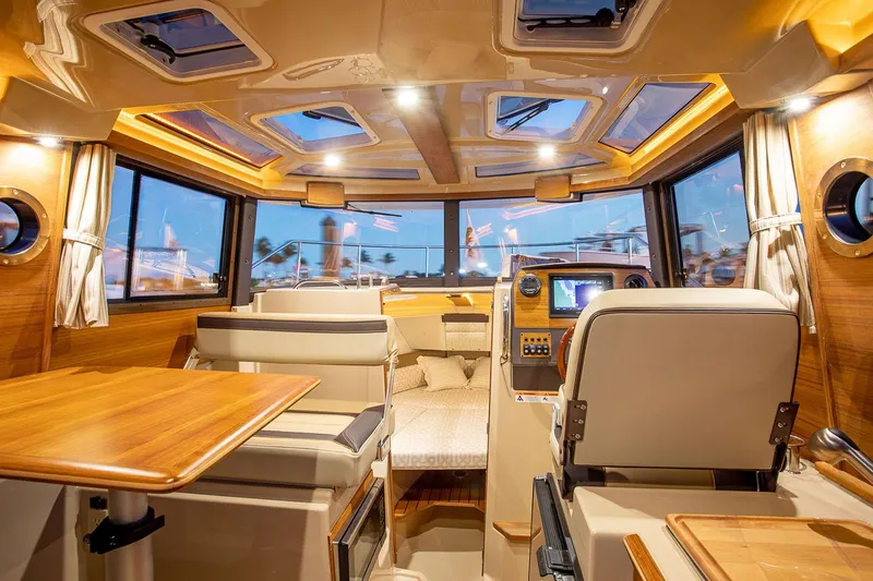 Slide: The Image of Manufacturer Provided Image: Luxurious interior of 2025 Ranger Tugs R-23 boat with elegant wood finishes and modern amenities. - 15