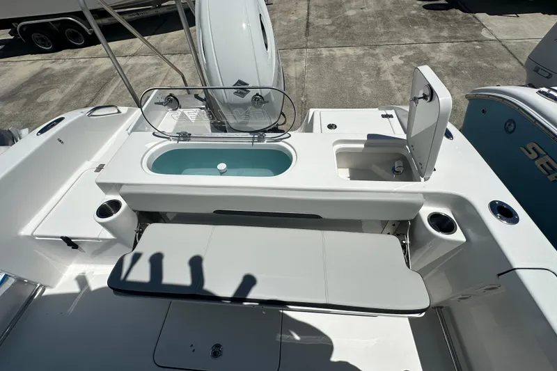 Slide: The Image of 2026 Sea Pro 222 Center Console boat with open storage compartments and seating area. - 12