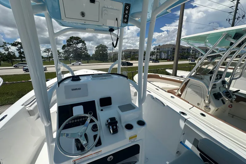 Slide: The Image of 2026 Sea Pro 222 Center Console boat interior with steering wheel and control panel. - 4
