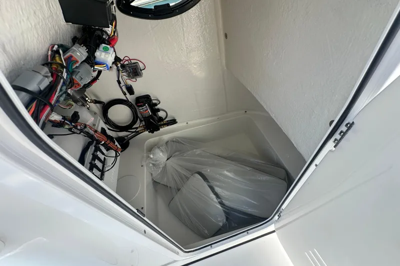 Slide: The Image of Interior view of 2026 Sea Pro 222 Center Console boat's storage compartment with wiring. - 9