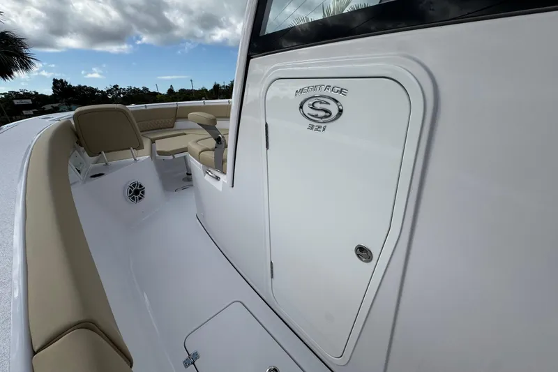 Slide: The Image of 2026 Sportsman Heritage 321 Center Console boat interior with seating and storage. - 13