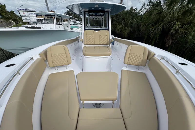Slide: The Image of 2026 Sportsman Heritage 321 Center Console boat with beige seating and sleek design. - 16