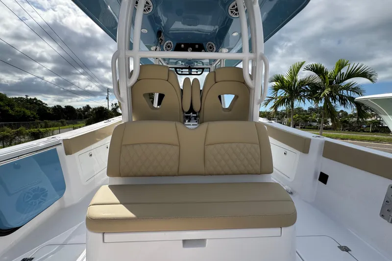 Slide: The Image of 2026 Sportsman Heritage 321 Center Console boat interior with beige seating and modern design. - 6