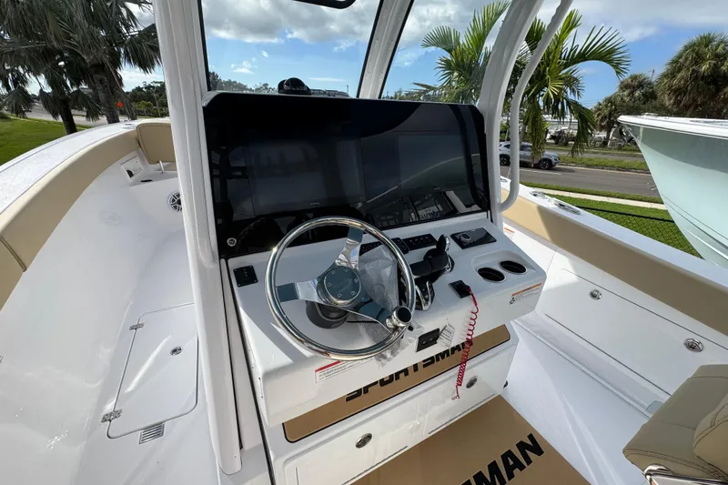 Slide: The Image of 2026 Sportsman Heritage 321 Center Console boat interior with steering wheel and dashboard. - 9