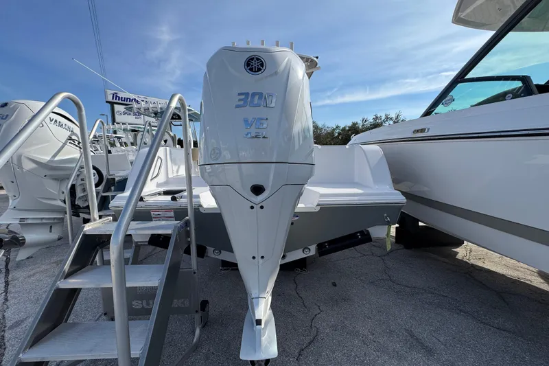 Slide: The Image of 2026 Sportsman Open 232 Center Console with Yamaha 300 V6 engine, displayed outdoors. - 1