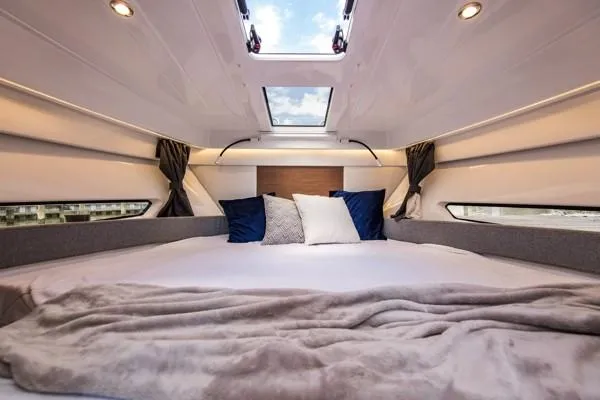 Slide: The Image of Luxurious cabin interior of 2024 Beneteau Antares 9 with skylight and cozy bedding. - 11