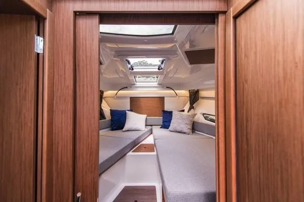 Slide: The Image of 2024 Beneteau Antares 9 cabin interior with skylight and cozy seating. - 12