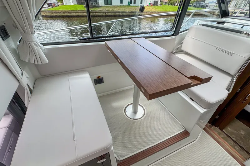 Slide: The Image of Interior of 2026 Beneteau Antares 9 boat with seating and wooden table. - 18