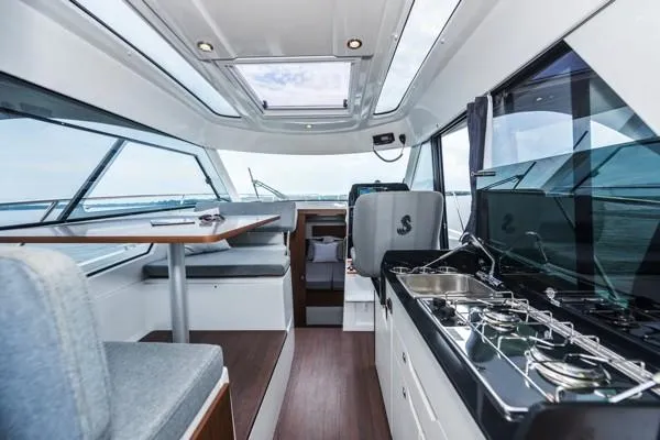 Slide: The Image of 2024 Beneteau Antares 9 interior with modern kitchen and dining area. - 8