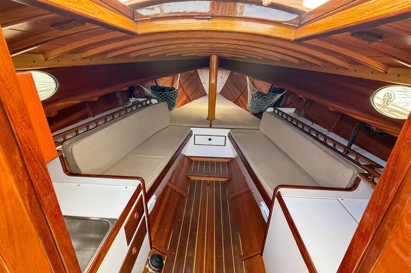 Slide: The Image of Interior of 2012 Herreshoff Custom Hyland Design "Rozinante" sailboat with wooden finish and seating. - 10