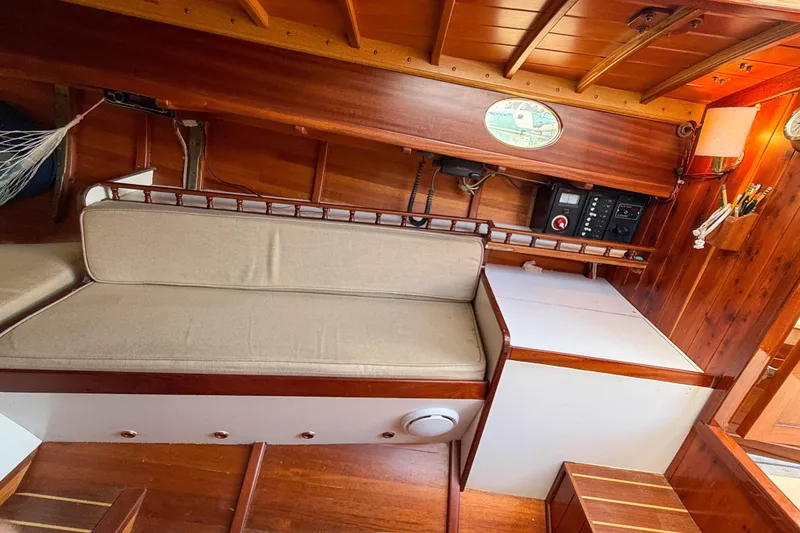 Slide: The Image of Interior of 2012 Herreshoff Custom Hyland Design "Rozinante" with wooden finish and seating area. - 11