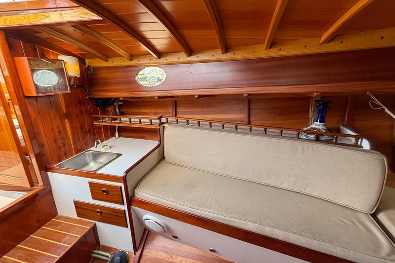 Slide: The Image of Interior of 2012 Herreshoff Custom Hyland Design "Rozinante" with wooden finish and compact sink. - 12