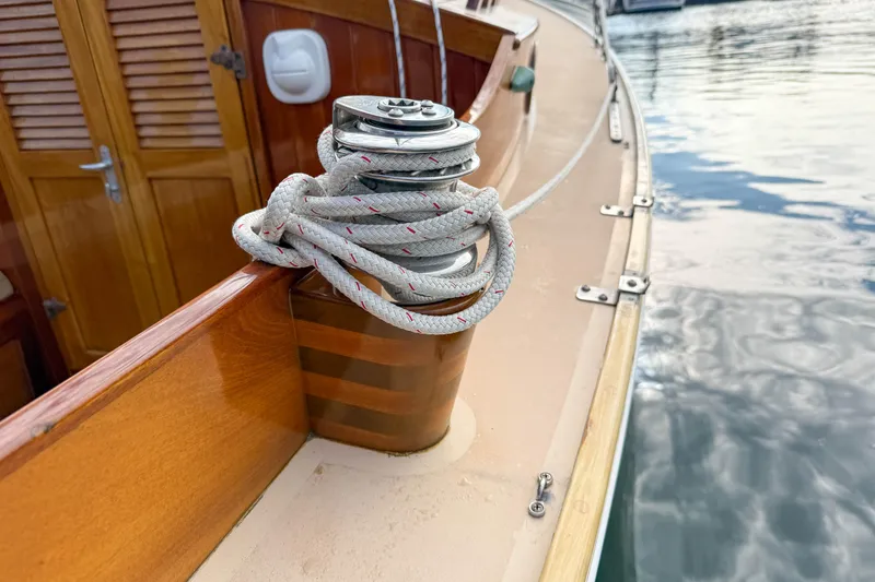Slide: The Image of 2012 Herreshoff Custom Hyland Design "Rozinante" sailboat with coiled rope on deck. - 24