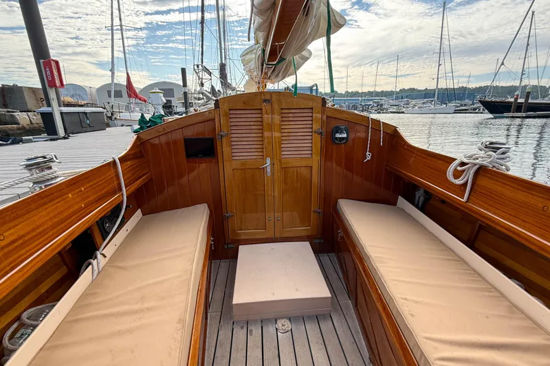 Slide: The Image of 2012 Herreshoff Custom Hyland Design "Rozinante" sailboat interior with wooden finish and seating. - 7