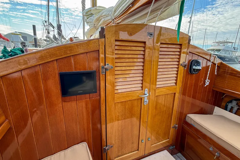 Slide: The Image of Wooden cabin doors on 2012 Herreshoff Custom Hyland Design "Rozinante" sailboat with Garmin display. - 8