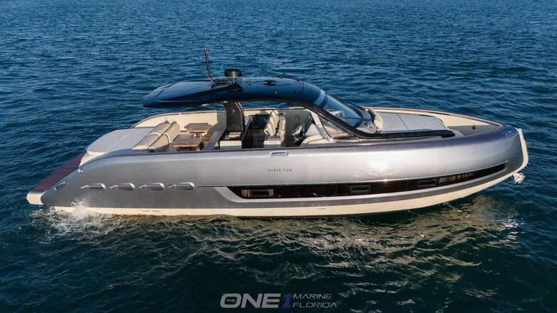 Slide: The Image of 2024 Invictus TT460 luxury yacht cruising on open water. - 1