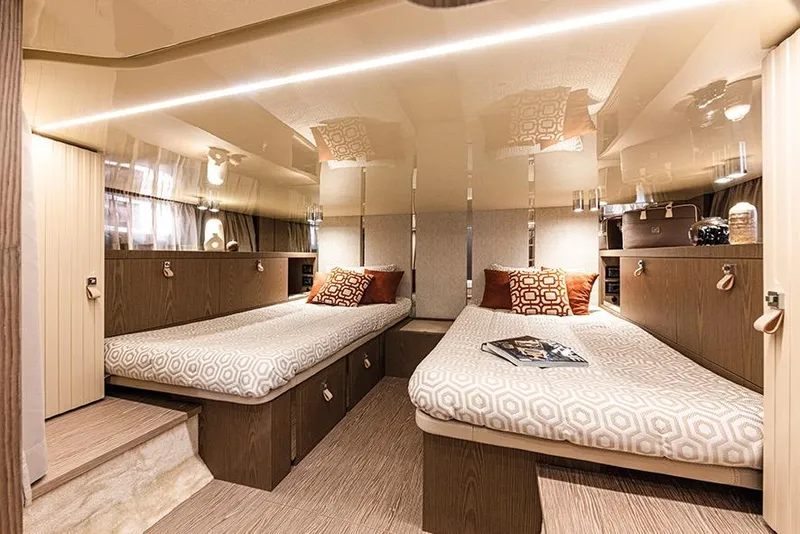 Slide: The Image of 2024 Invictus TT460 yacht interior with twin beds, modern design, and elegant decor. - 10