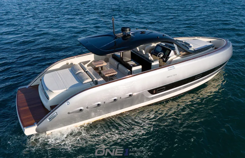 Slide: The Image of 2024 Invictus TT460 luxury yacht cruising on open water. - 3