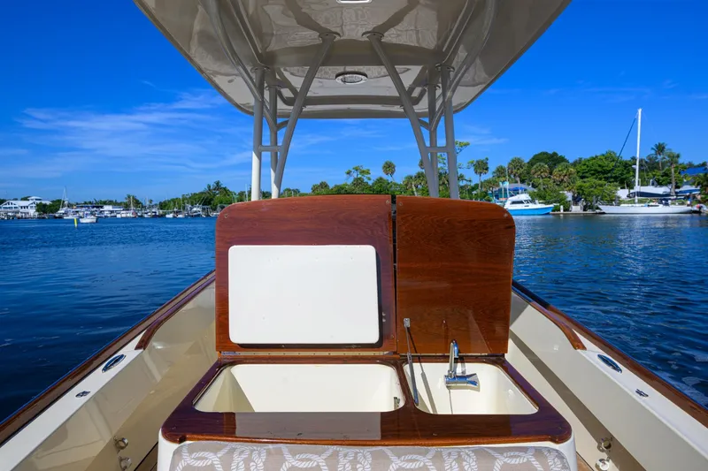 Slide: The Image of 2014 Hinckley Talaria 29C boat interior with sink, docked on a sunny day. - 13