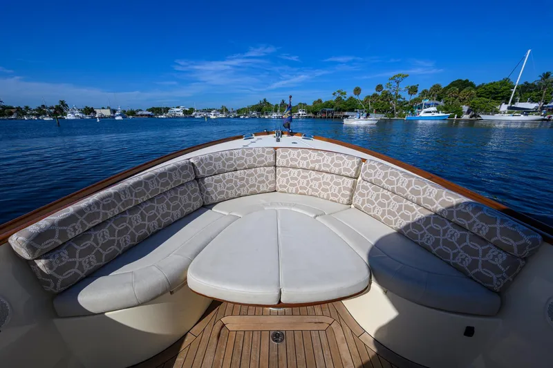 Slide: The Image of 2014 Hinckley Talaria 29C boat with elegant seating, docked on a sunny day. - 17