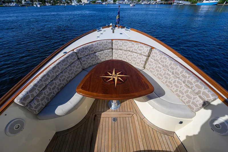 Slide: The Image of Hinckley Talaria 29C 2014 boat with elegant seating and wooden table on calm water. - 18