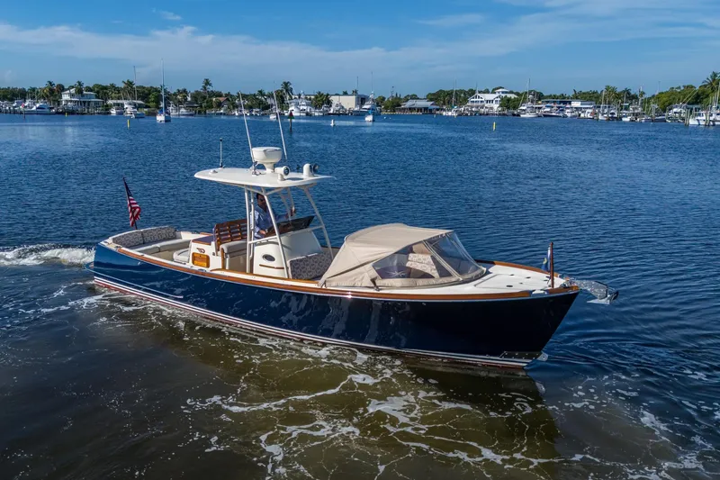 Slide: The Image of 2014 Hinckley Talaria 29C cruising on a sunny day in a marina. - 3