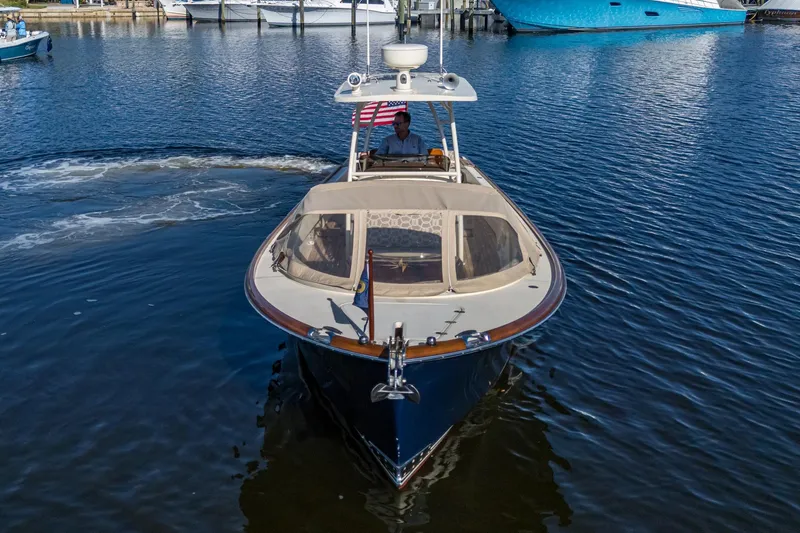 Slide: The Image of 2014 Hinckley Talaria 29C boat cruising on calm water, front view. - 4
