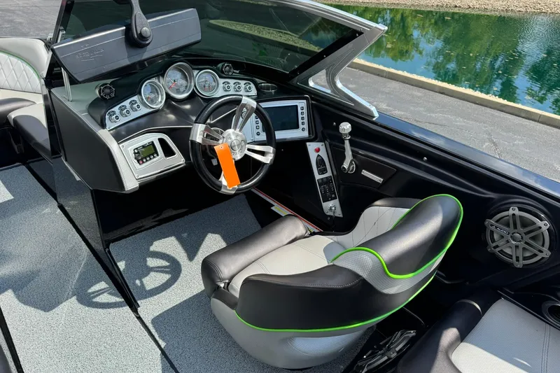 Slide: The Image of Interior of a 2015 MasterCraft X30 boat, featuring a sleek dashboard and modern controls. - 10