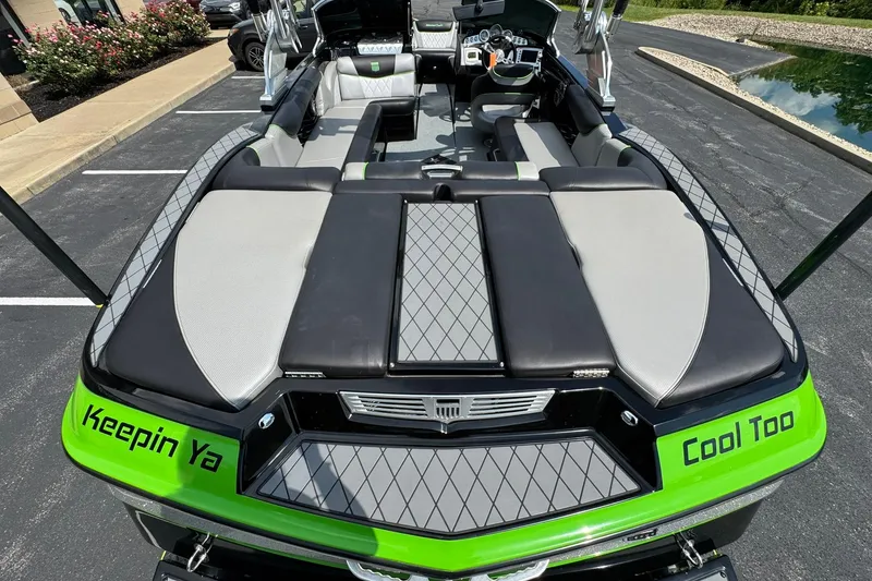 Slide: The Image of 2015 MasterCraft X30 boat interior with custom seating and green accents. - 17
