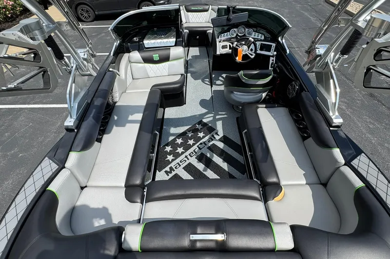 Slide: The Image of 2015 MasterCraft X30 boat interior with sleek seating and modern dashboard. - 18