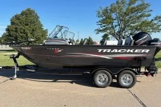 Slide: The Image of 2015 Tracker Targa V-18 Combo boat on trailer, parked outdoors. - 3