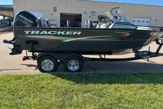 Slide: The Image of 2015 Tracker Targa V-18 Combo boat on trailer, parked outdoors. - 7