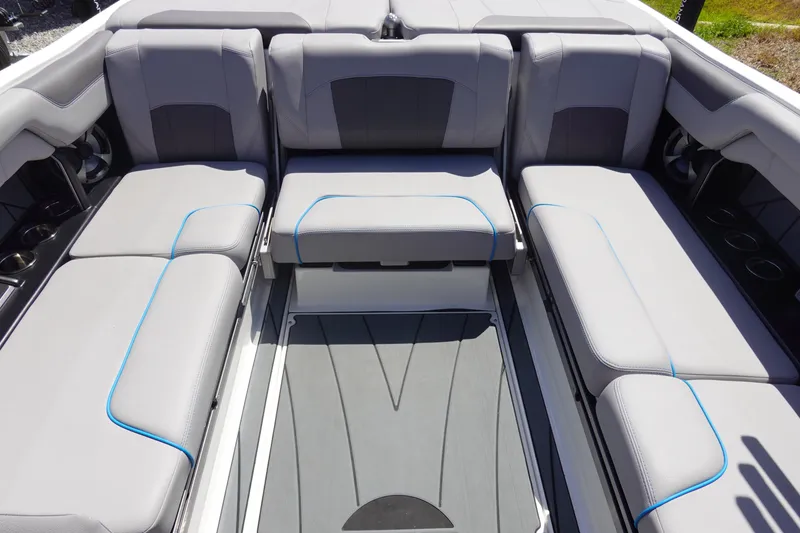 Slide: The Image of 2021 Malibu Wakesetter 25 LSV interior with gray seating and blue accents. - 12