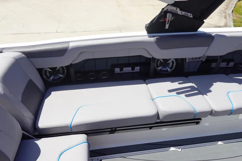 Slide: The Image of 2021 Malibu Wakesetter 25 LSV interior with gray seating and built-in speakers. - 14