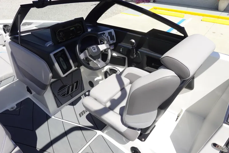 Slide: The Image of 2021 Malibu Wakesetter 25 LSV boat interior with modern dashboard and steering wheel. - 16