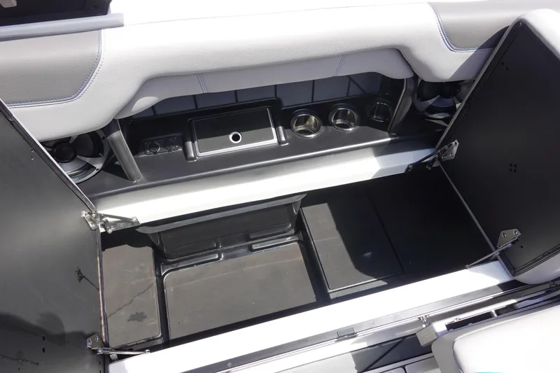 Slide: The Image of 2021 Malibu Wakesetter 25 LSV interior storage compartment with cup holders and speaker. - 23