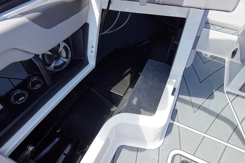 Slide: The Image of Interior view of 2021 Malibu Wakesetter 25 LSV boat, featuring storage and speaker system. - 29