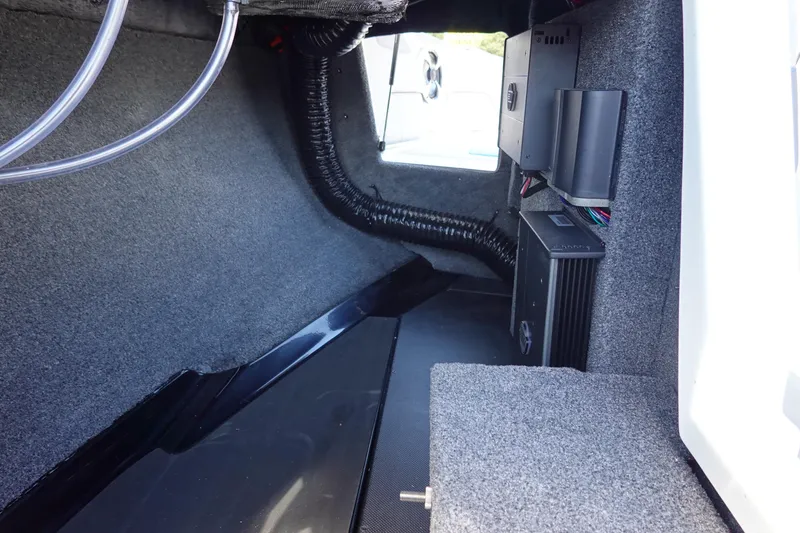 Slide: The Image of Interior view of 2021 Malibu Wakesetter 25 LSV boat compartment with wiring and components. - 30
