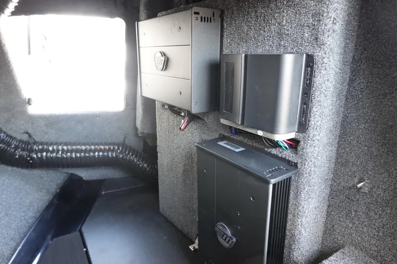 Slide: The Image of 2021 Malibu Wakesetter 25 LSV interior electronics setup with amplifiers and wiring. - 31