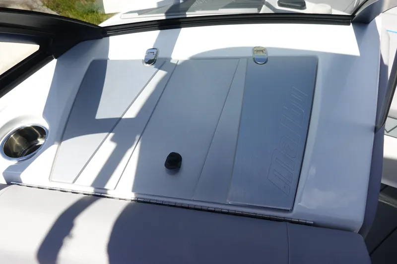 Slide: The Image of 2021 Malibu Wakesetter 25 LSV dashboard with cup holder and storage compartment. - 35