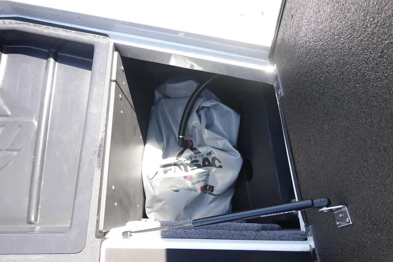 Slide: The Image of 2021 Malibu Wakesetter 25 LSV ballast compartment with ballast bag and hose. - 41