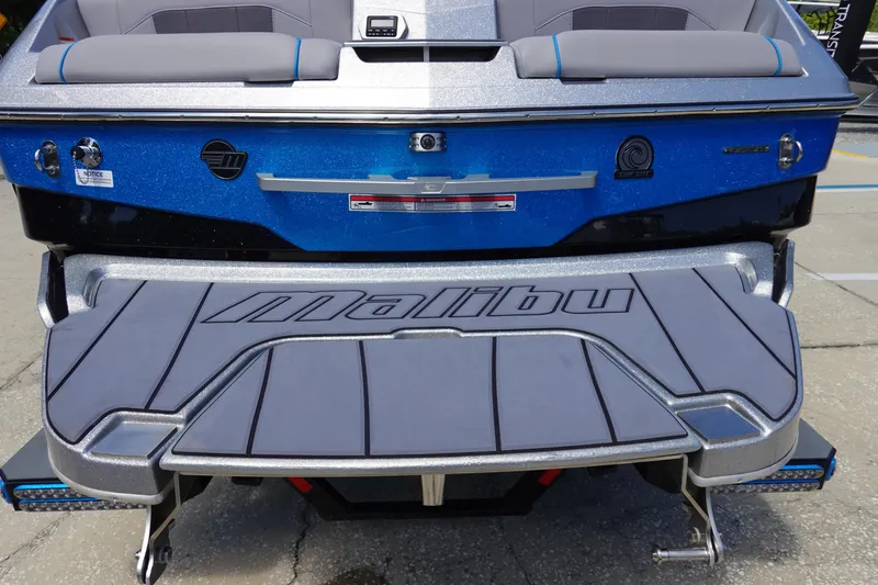 Slide: The Image of 2021 Malibu Wakesetter 25 LSV boat rear view with swim platform and logo. - 6